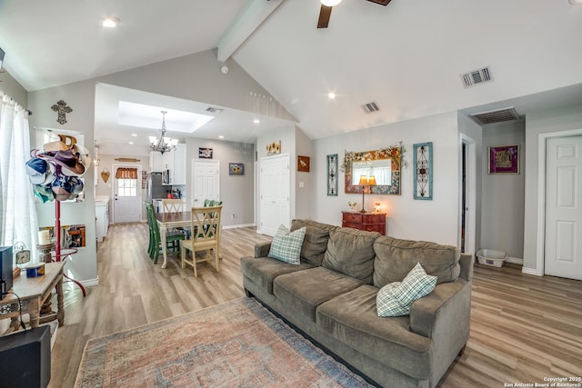 living area featuring beam ceiling, visible vents, baseboards, and light wood-style floors