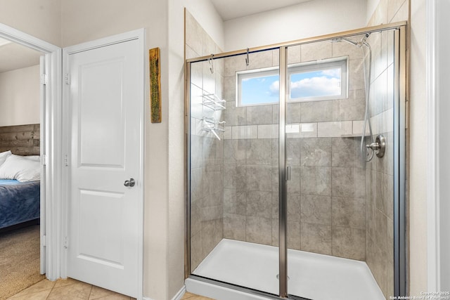 bathroom featuring connected bathroom, a shower stall, and tile patterned flooring