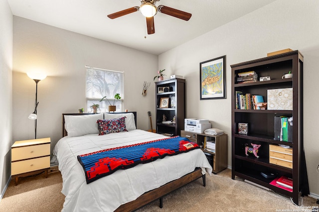 bedroom with ceiling fan, baseboards, and carpet