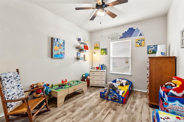 rec room with a ceiling fan and wood finished floors