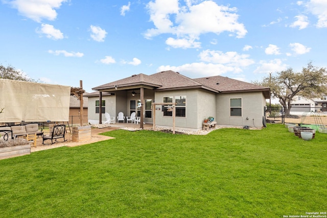 rear view of property with a yard, a patio area, a ceiling fan, and fence