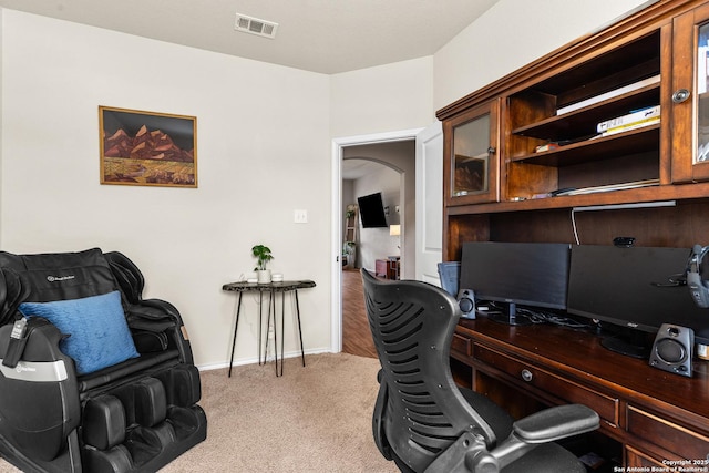 home office with arched walkways, visible vents, carpet floors, and baseboards