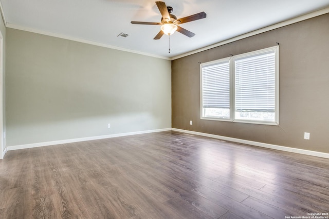 unfurnished room with visible vents, ornamental molding, a ceiling fan, wood finished floors, and baseboards