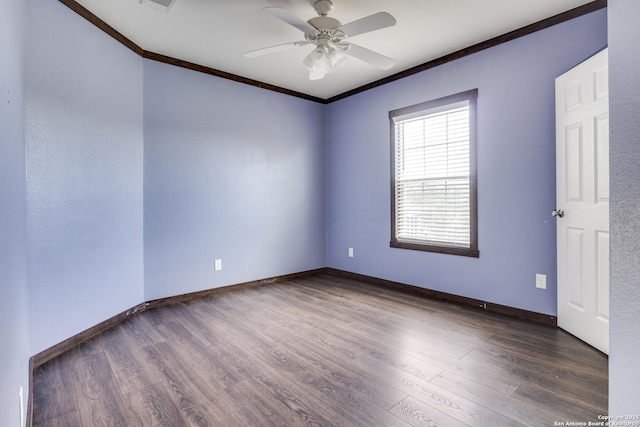 unfurnished room with crown molding, wood finished floors, and baseboards