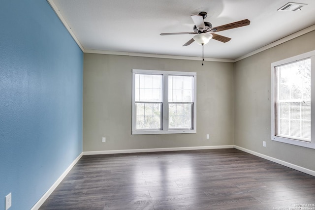 unfurnished room with crown molding, dark wood-style floors, visible vents, and baseboards