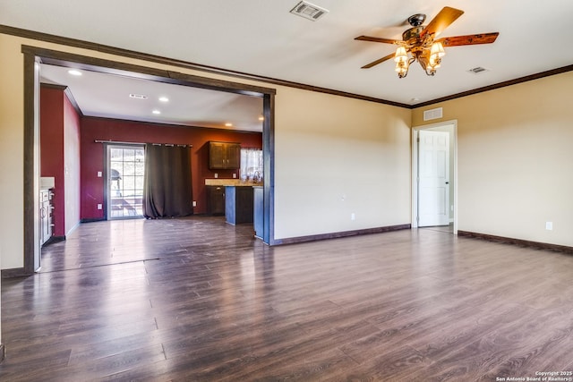 unfurnished living room featuring dark wood finished floors, visible vents, and ornamental molding