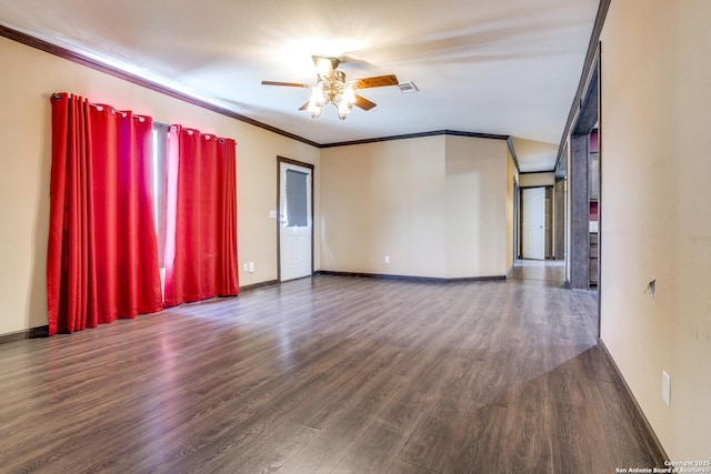 spare room featuring ornamental molding, baseboards, a ceiling fan, and wood finished floors