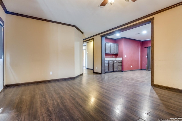 unfurnished living room with baseboards, ceiling fan, dark wood-style flooring, and crown molding