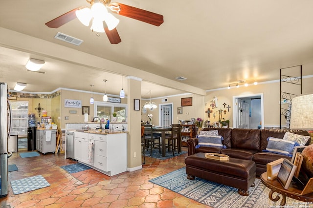 living room featuring crown molding, a ceiling fan, and visible vents