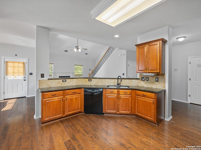 kitchen with dishwasher, brown cabinetry, backsplash, and a sink