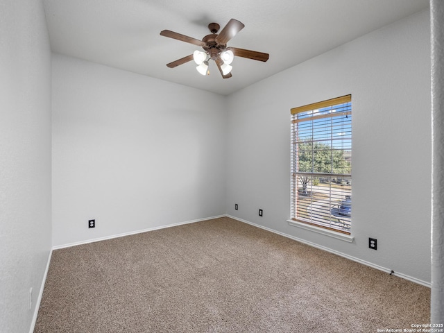 carpeted spare room with baseboards and ceiling fan