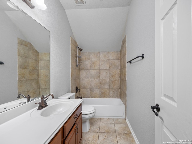 bathroom featuring visible vents, toilet, tub / shower combination, vanity, and a textured wall