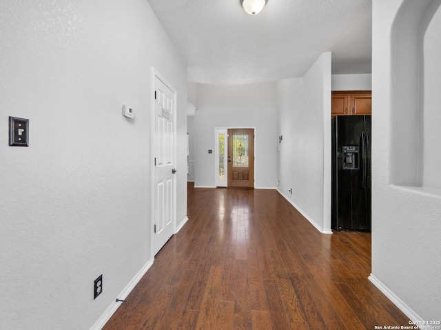 hall with baseboards and dark wood-style flooring