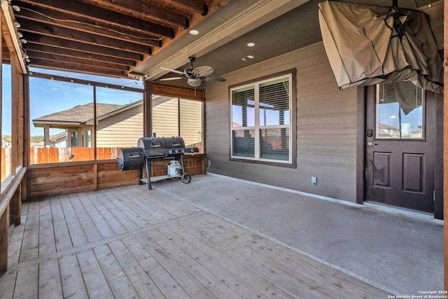 deck featuring area for grilling, a ceiling fan, and fence