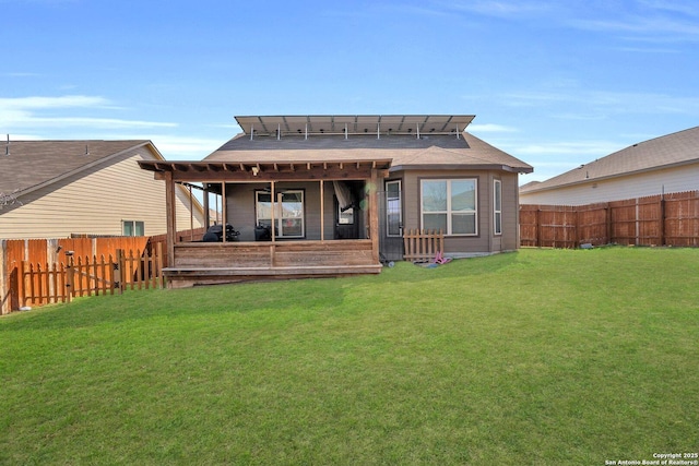 back of house featuring a lawn and a fenced backyard