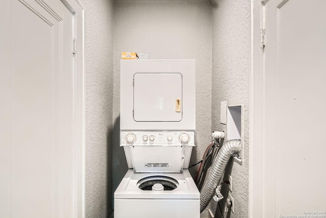 clothes washing area featuring laundry area and stacked washer and dryer