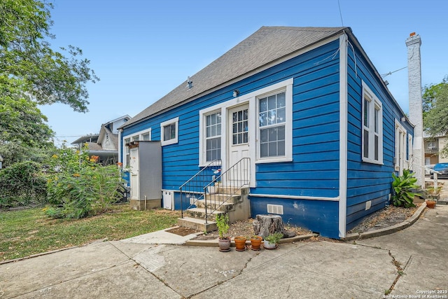 back of house featuring entry steps and crawl space