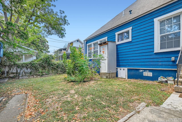 view of property exterior with a lawn