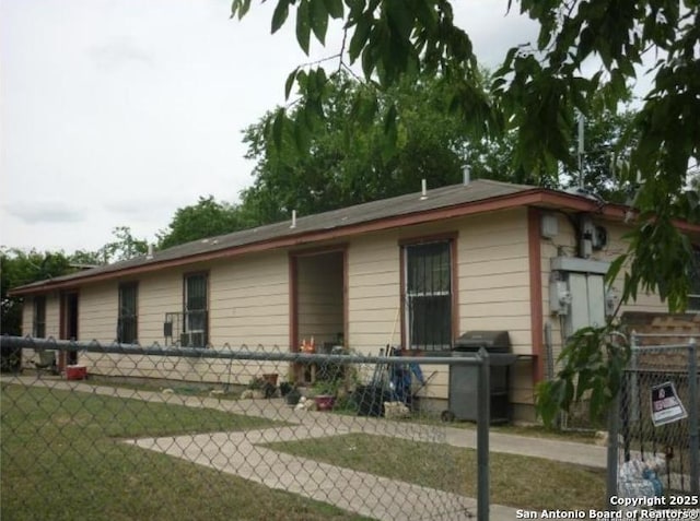 view of front of house with a front yard and fence