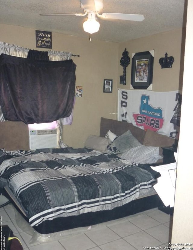 bedroom featuring tile patterned flooring, cooling unit, a textured ceiling, and ceiling fan