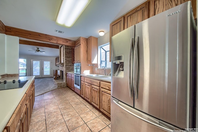 kitchen featuring a sink, stainless steel appliances, visible vents, and light countertops