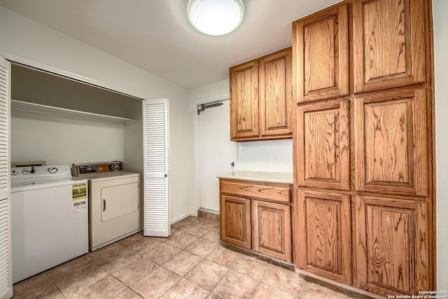 clothes washing area featuring washer and dryer, laundry area, and light tile patterned floors