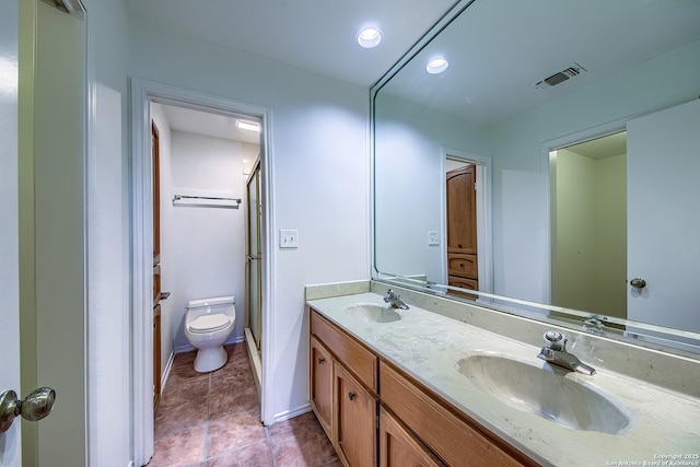 full bath featuring double vanity, toilet, visible vents, and a sink