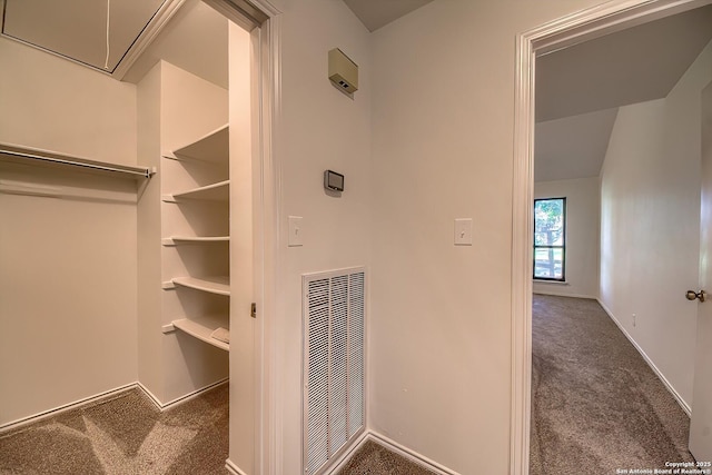 interior space with baseboards, visible vents, attic access, and carpet