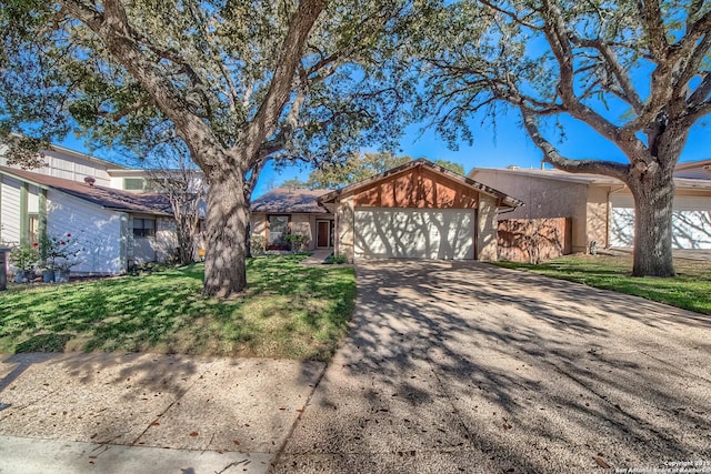 view of front of home featuring a garage, concrete driveway, and a front lawn