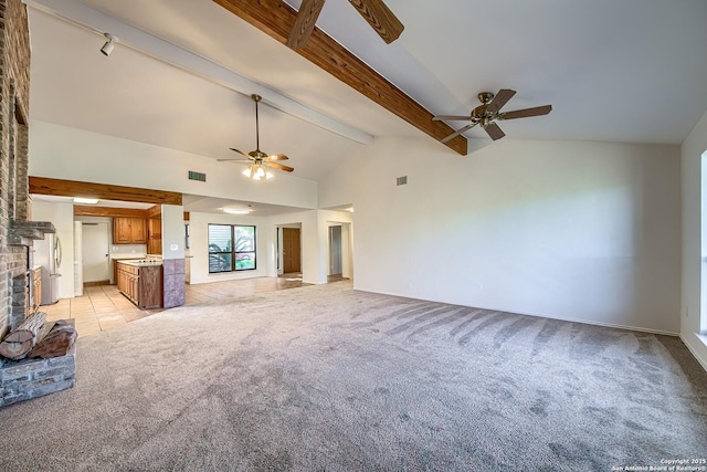 unfurnished living room with beamed ceiling, visible vents, a fireplace, light colored carpet, and ceiling fan