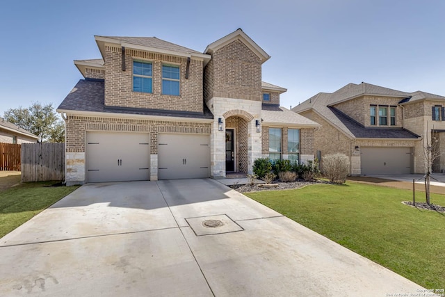 view of front of house with brick siding, driveway, an attached garage, and fence