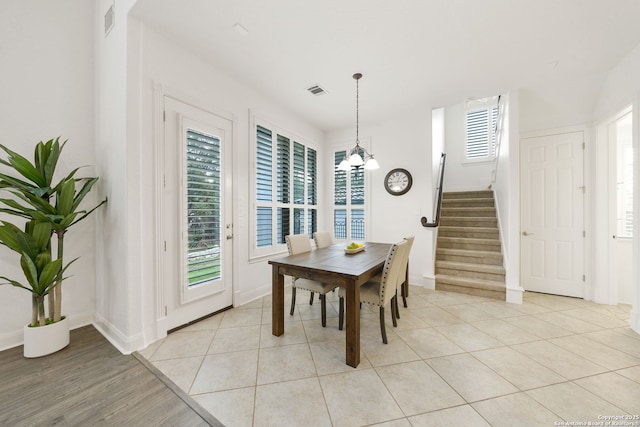 dining area with stairway, light tile patterned flooring, visible vents, and a wealth of natural light