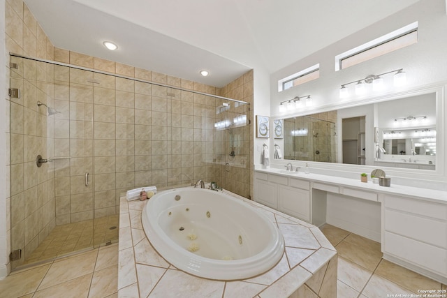 bathroom with tile patterned flooring, a stall shower, vanity, and a whirlpool tub