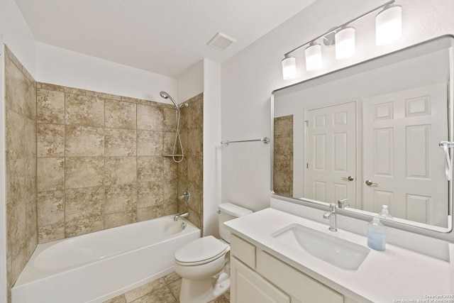 bathroom with tile patterned floors, visible vents, toilet, bathtub / shower combination, and vanity