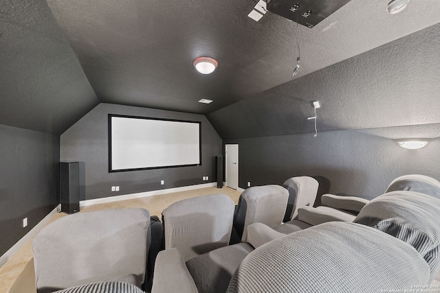 cinema room featuring lofted ceiling, a textured ceiling, carpet floors, baseboards, and a textured wall