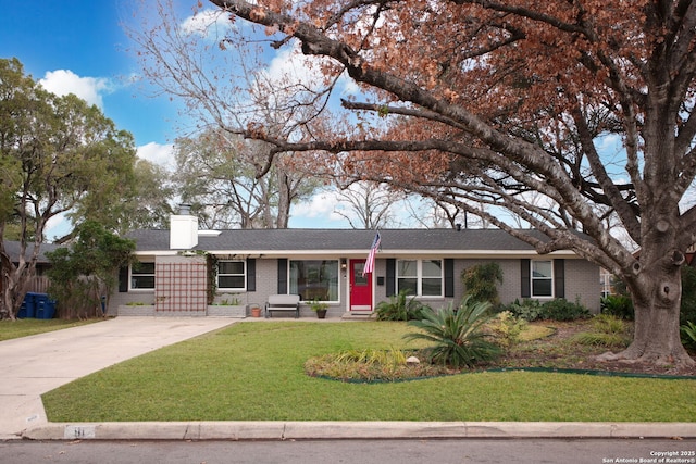 single story home with a front yard, brick siding, driveway, and a chimney