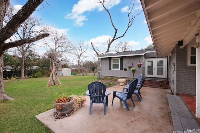 view of patio with french doors, an outbuilding, a storage shed, and fence