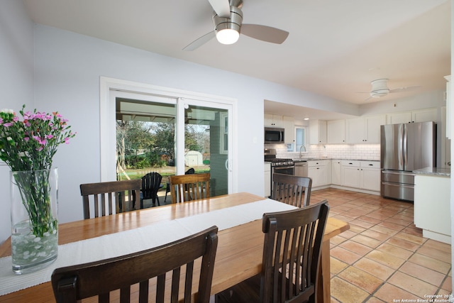 dining space with light tile patterned flooring and ceiling fan