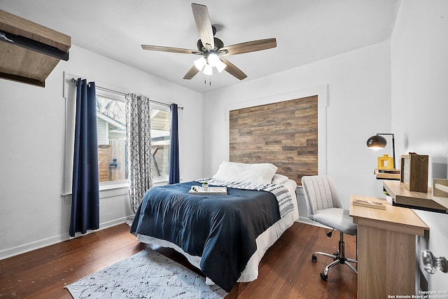 bedroom with ceiling fan, baseboards, and wood finished floors