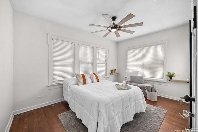 bedroom with ceiling fan, baseboards, and hardwood / wood-style floors