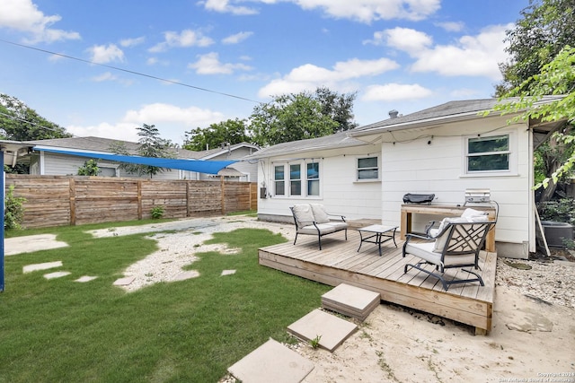 back of property with central air condition unit, a lawn, a wooden deck, and fence