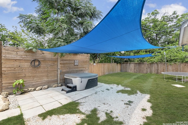 view of patio / terrace with a fenced backyard and a trampoline