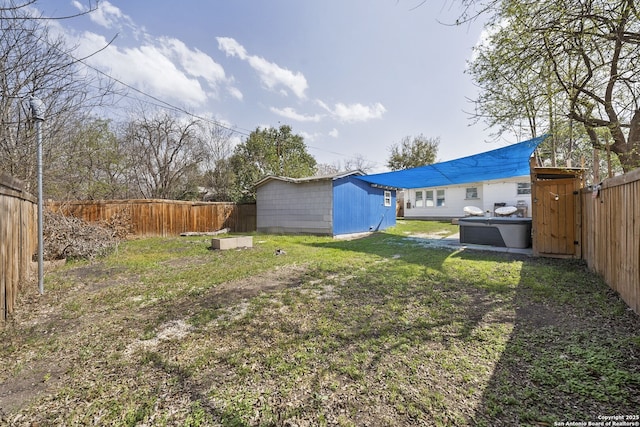 view of yard with a fenced backyard, a storage shed, and an outdoor structure