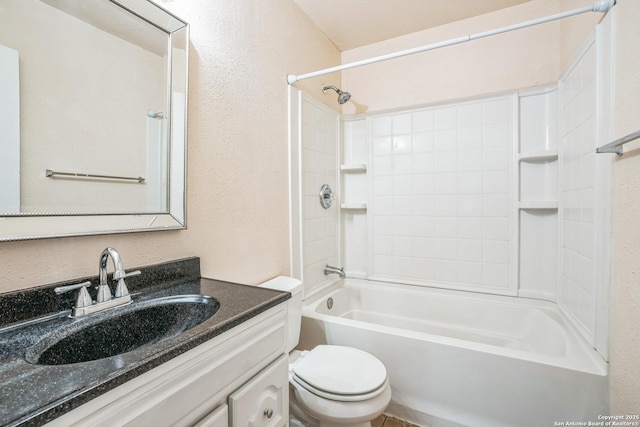 full bath with tub / shower combination, toilet, vanity, and a textured wall