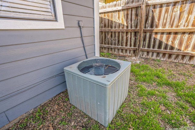 exterior details featuring cooling unit and fence