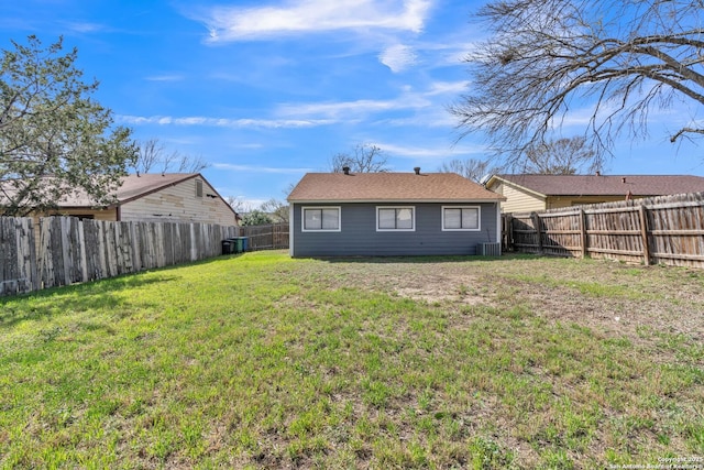 back of house featuring cooling unit, a lawn, and a fenced backyard