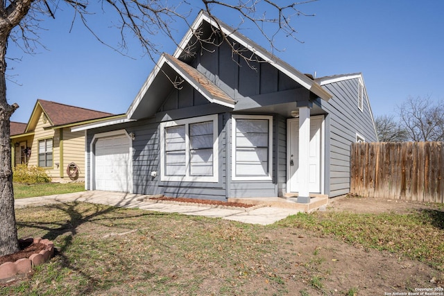 ranch-style home featuring board and batten siding, a front yard, fence, and a garage