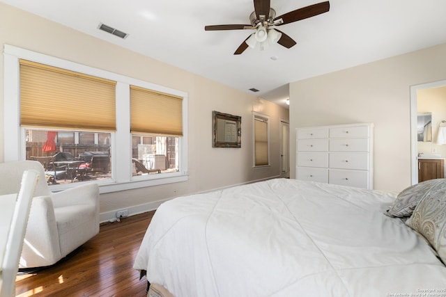 bedroom with visible vents, ensuite bathroom, baseboards, and wood-type flooring