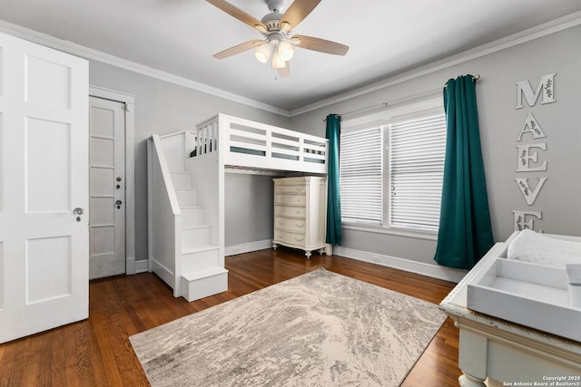 bedroom featuring crown molding, wood finished floors, baseboards, and ceiling fan