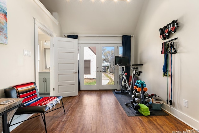 exercise area with vaulted ceiling, french doors, baseboards, and hardwood / wood-style flooring